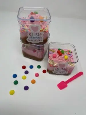 A couple of tubs filled with pink and white slime.