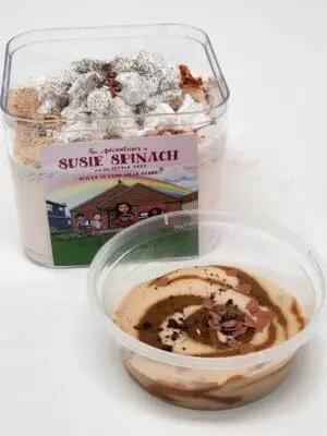 A container of rice krispie treats next to a bowl of pudding.