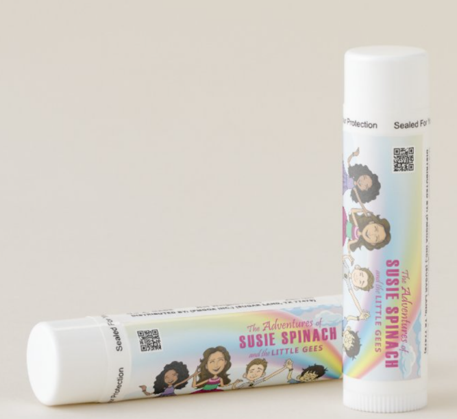 A couple of tubes of lip balm sitting on top of a table.