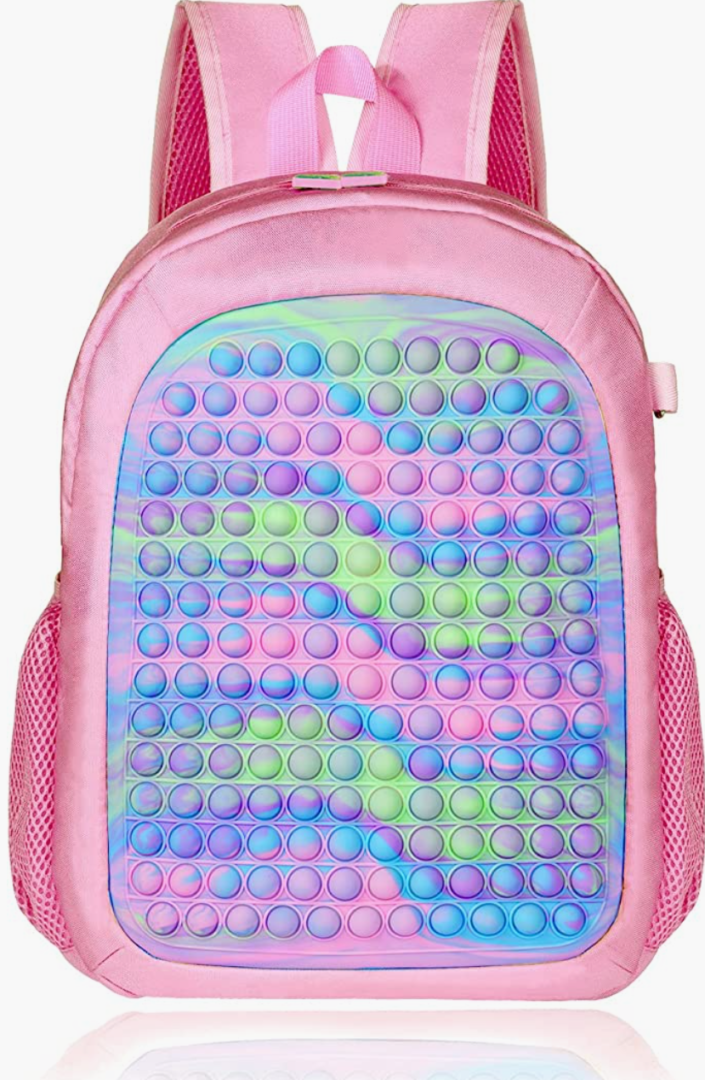 A pink backpack with blue, green and purple bubbles on it.