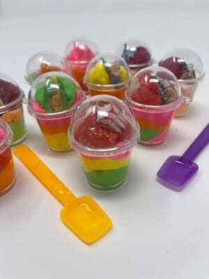 A group of plastic cups filled with jelly and ice cream.