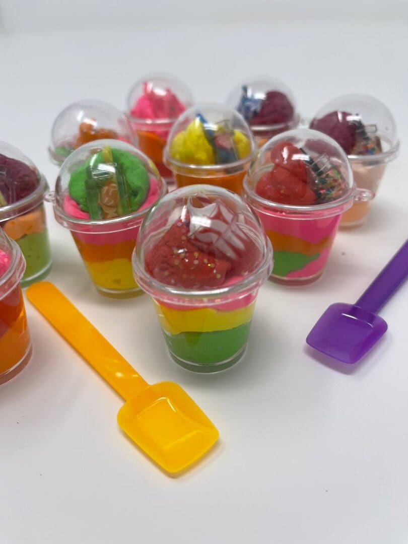 A group of plastic cups filled with jelly and ice cream.