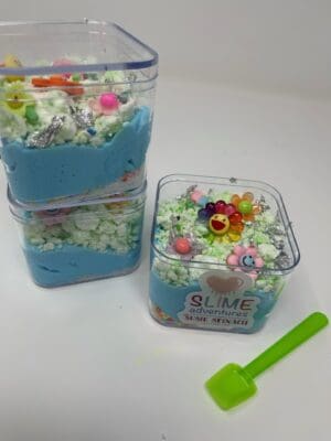 A group of three plastic containers filled with blue and white stuff.