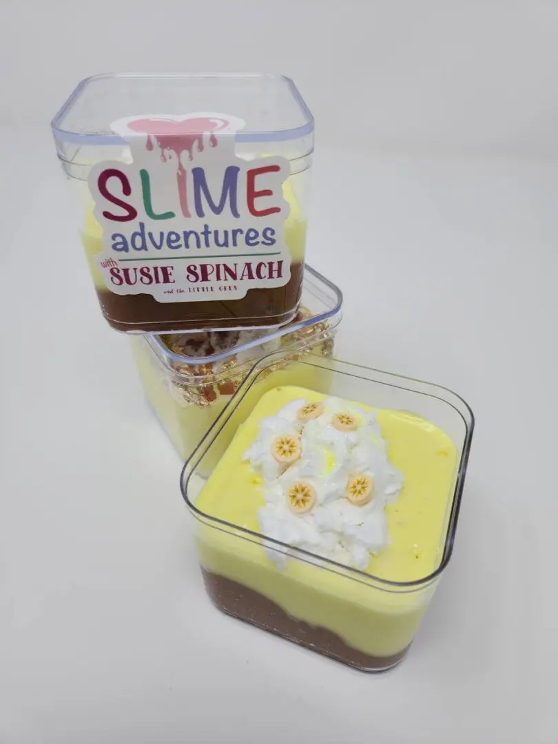 Three containers of yellow and brown slime with flowers.