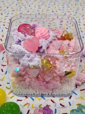 A plastic container filled with pink and white candy.