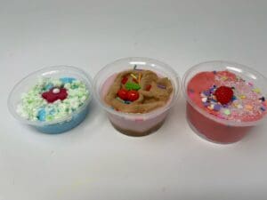 Three different desserts are in plastic containers.