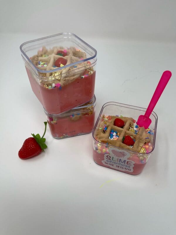 A strawberry and waffle ice cream in plastic containers.